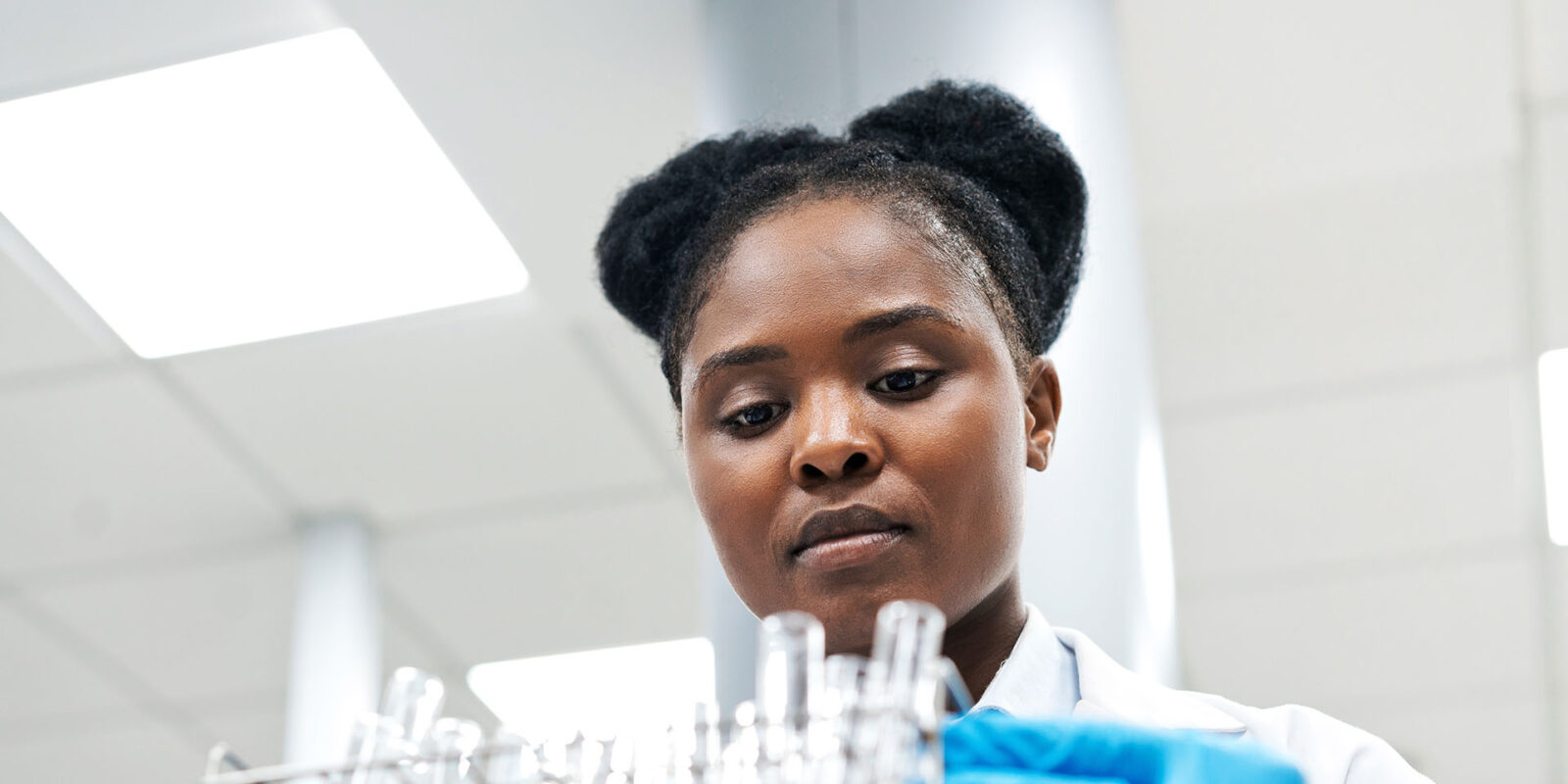 Student holding test tubes in lab