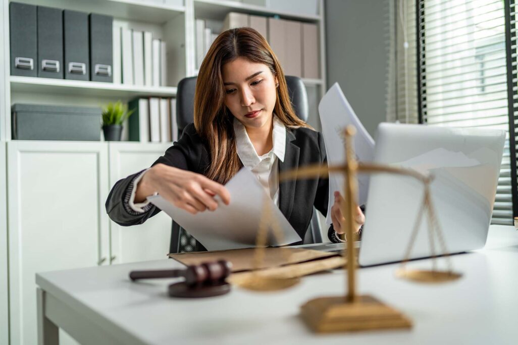 bdt_bac_image-1 Criminologist reviewing documents in office