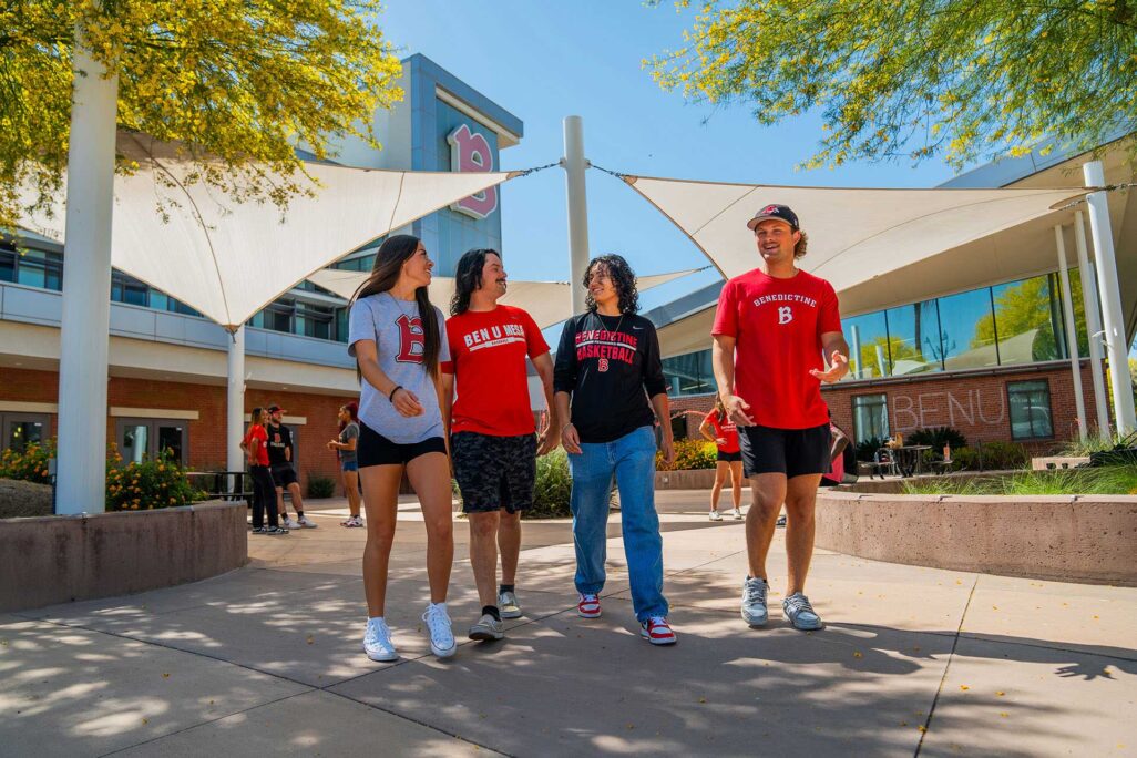 bdt-about-image-1 Students in BenU shirts in front of campus building